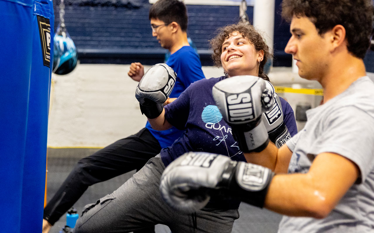 students kicking bag in a kickboxing class 