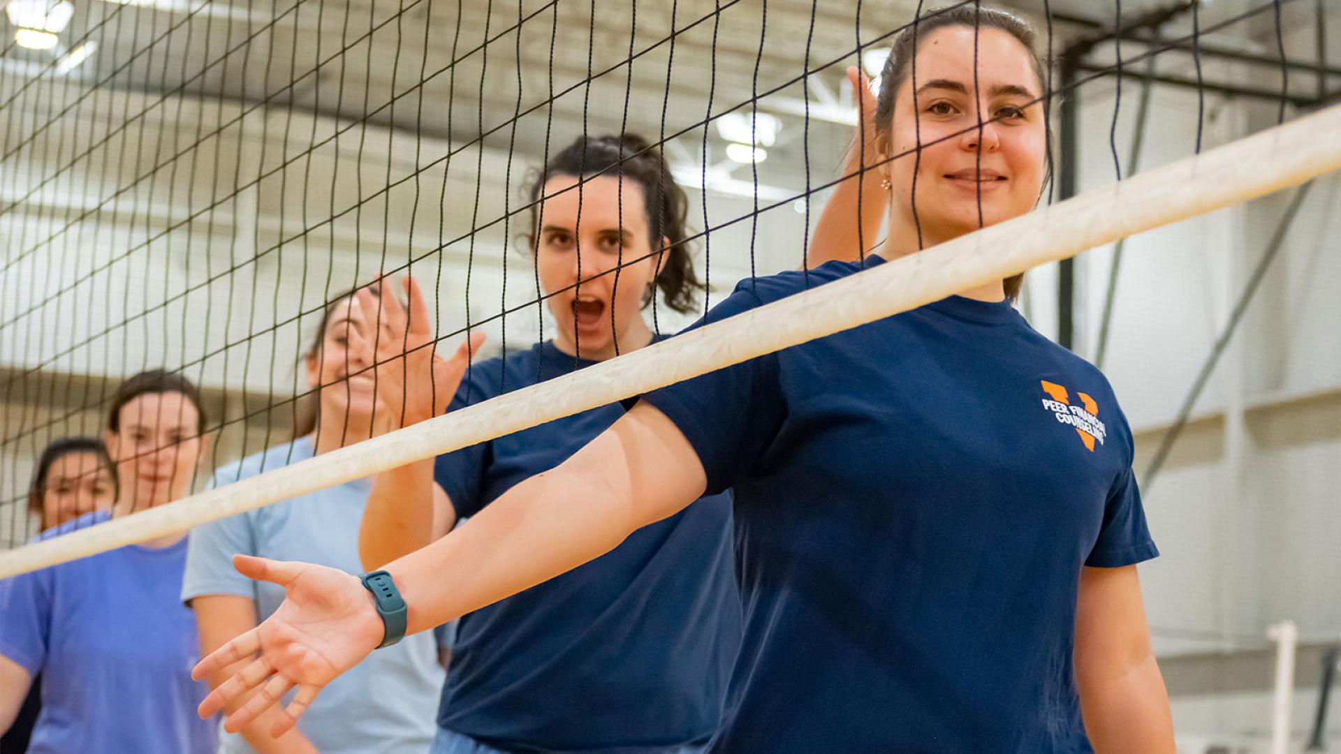 female uva students reaching out for high fives after a volleyball game spring intramural sports 